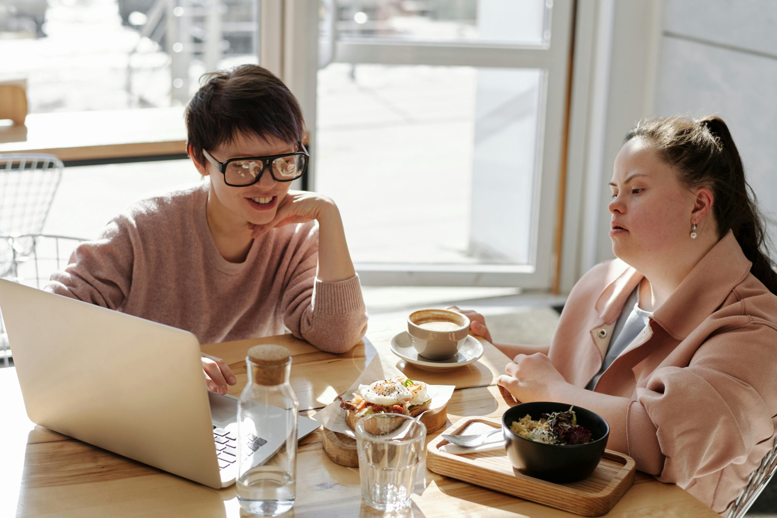 A participant laughing with their support worker