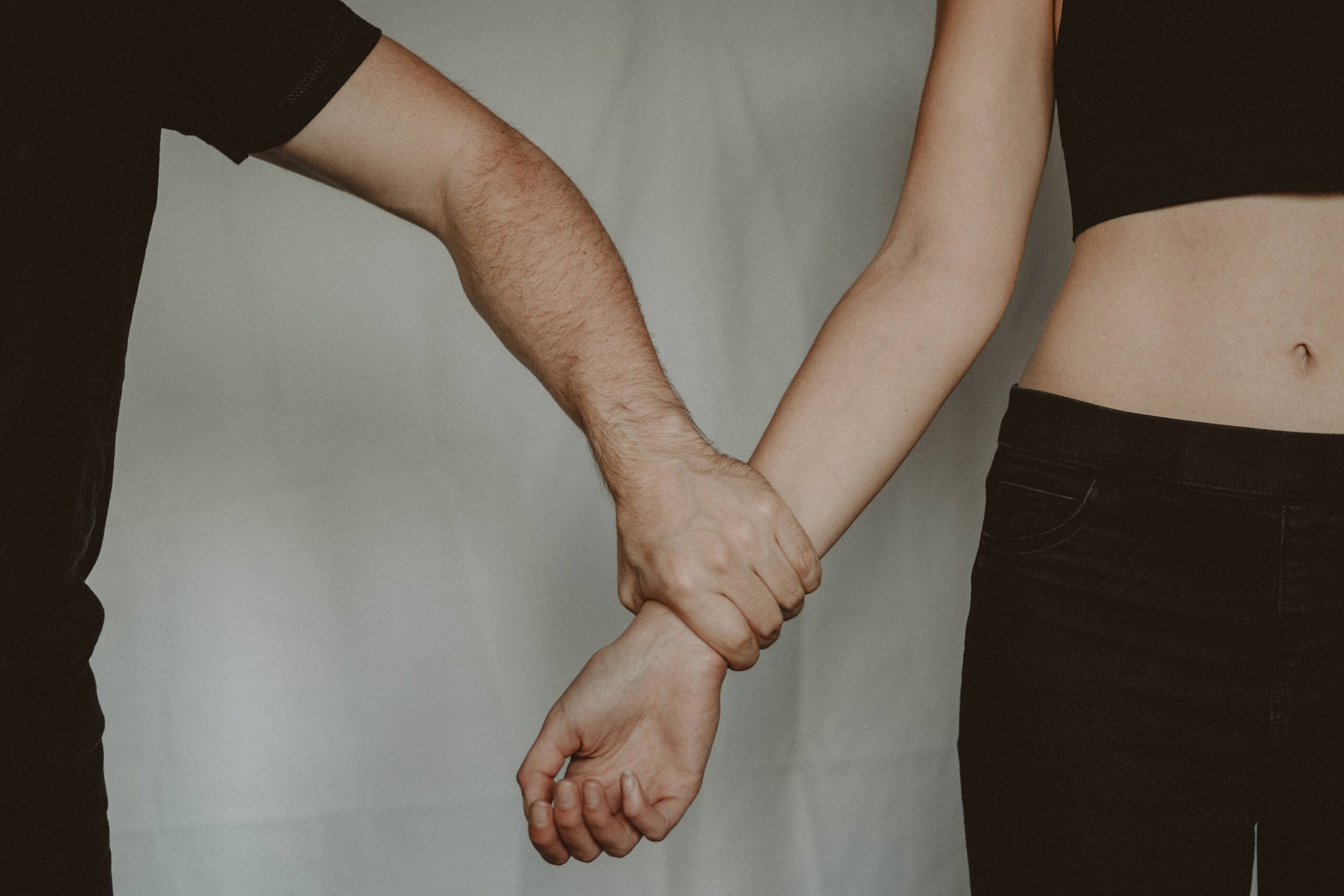 A support worker holding a participant's hands