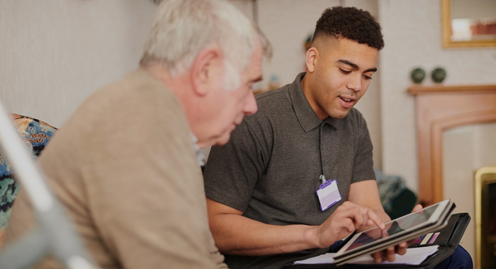 A carer spending time with an elderly participant