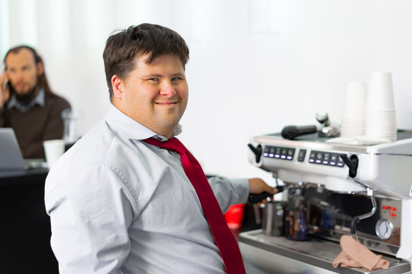 A participant working confidently in a café role