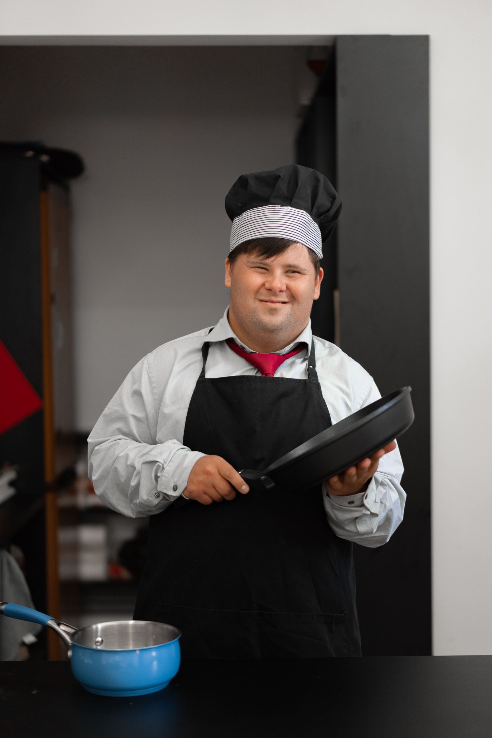 A participant cooking in the kitchen with support